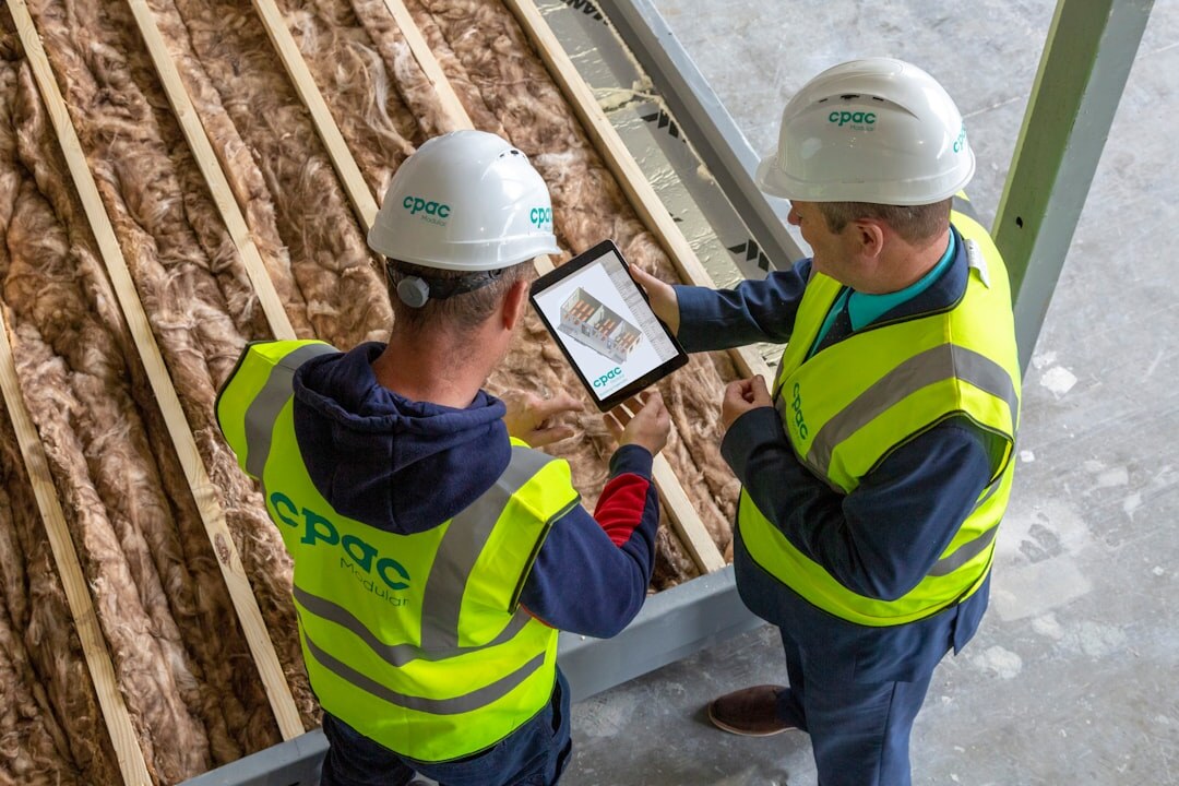 Two colleagues reviewing a production plan on a tablet