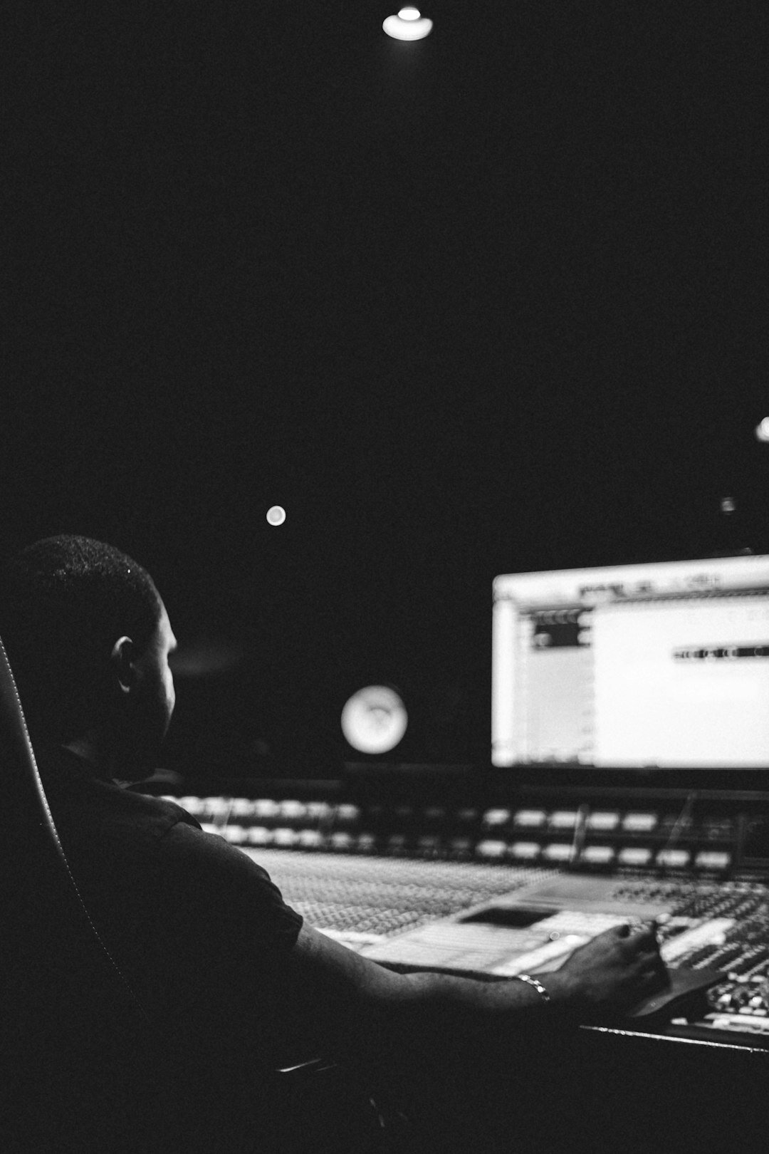 Director watching multiple video feeds on production monitors