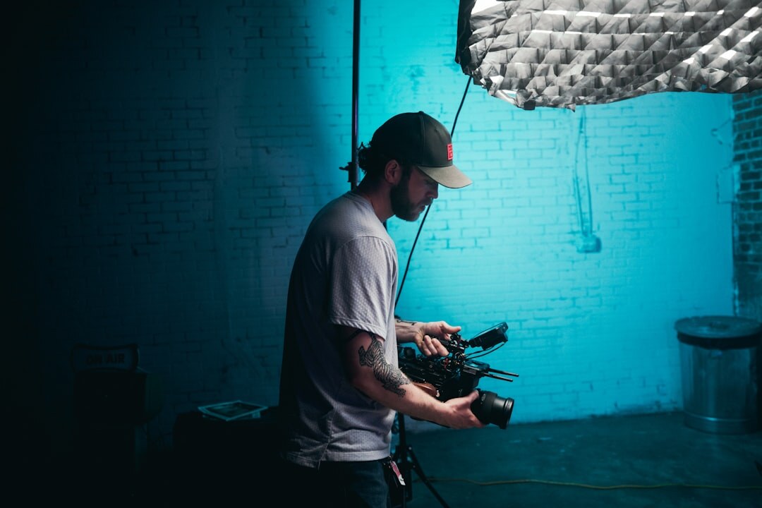 Lighting technician adjusting studio lighting rig