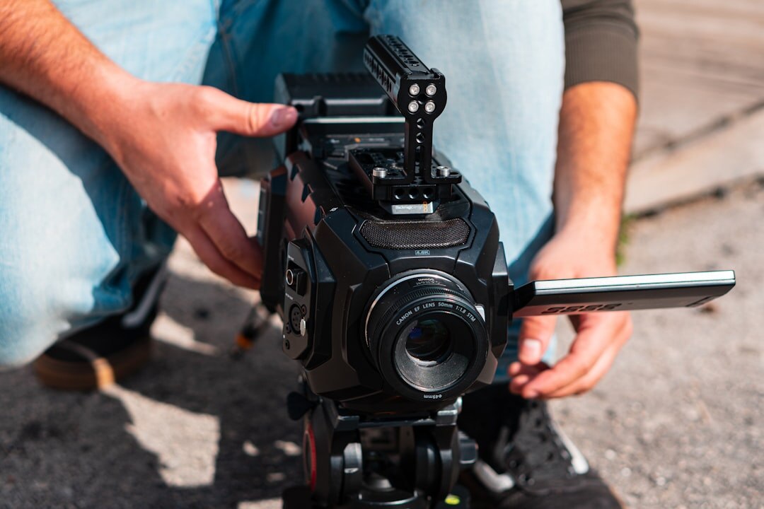 Camera operator filming a scene with a professional video camera
